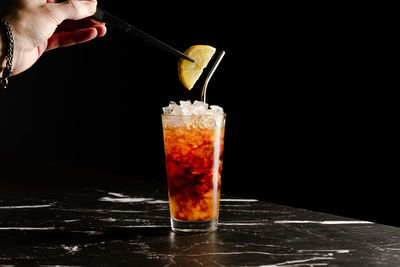 Close-up of drink in glass against black background