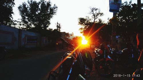People on road against sky during sunset