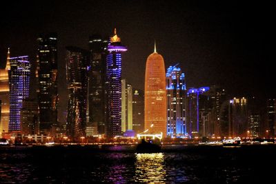 Illuminated buildings in city at night