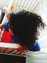 Close-up of girl holding mobile phone at home