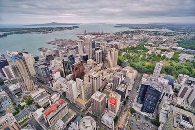 High angle view of cityscape by sea against sky