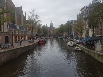 Boats in canal along buildings