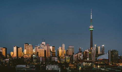 Modern buildings in city against clear sky