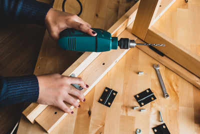 High angle view of man working on wooden table