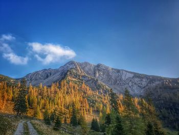 Scenic view of mountains against blue sky