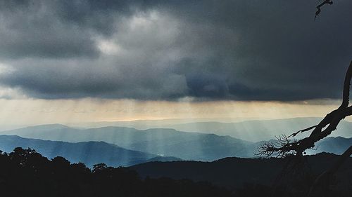 Scenic view of silhouette mountains against sky at sunset