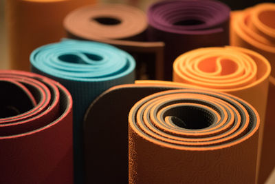 Close-up of multi colored rolled exercise mats