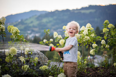 Portrait of smiling girl holding plants