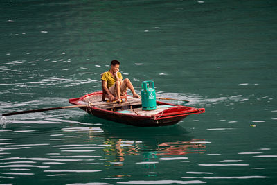 Man sitting in boat on lake