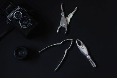 High angle view of person wearing ring on table against black background