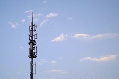 Low angle view of communications tower against sky