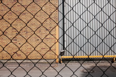 Wall seen through chainlink fence