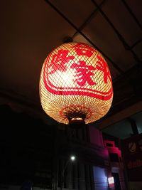 Low angle view of illuminated lamp in city at night