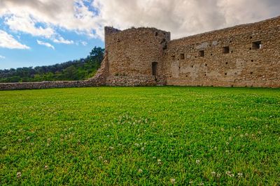 View of old ruin building in field