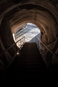 Staircase in tunnel against building