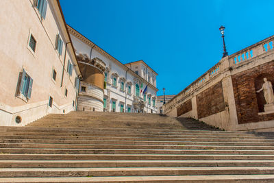 Low angle view of steps against clear blue sky