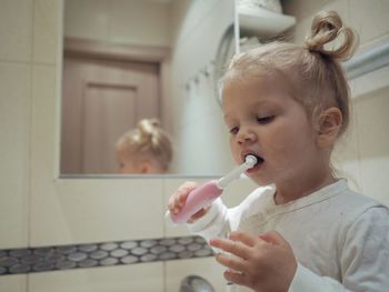 Girl brushing teeth at home