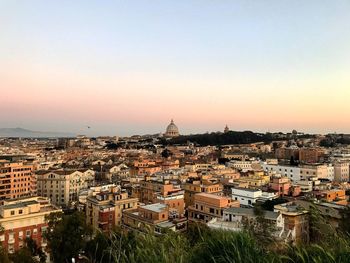 Aerial view of townscape against sky at sunset