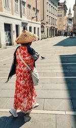 Rear view of woman walking on street