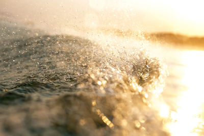 Close-up of wet surface against sky during winter