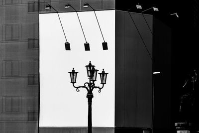 Close-up of lamp hanging against built structure