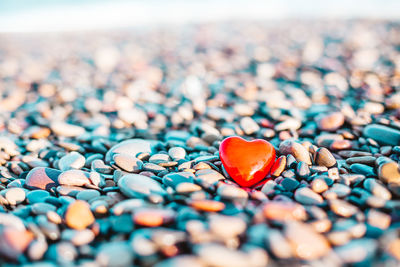 Close-up of heart shape stone on pebbles