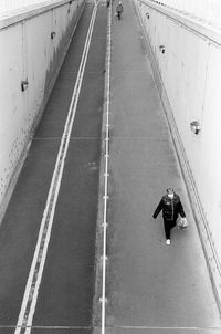 High angle view of man walking on road