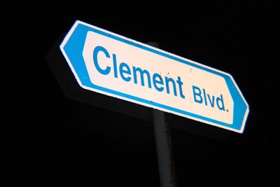 Low angle view of road sign at night