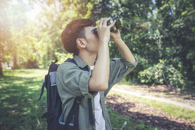 Young woman photographing through smart phone
