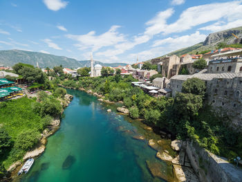 High angle view of river in city against sky