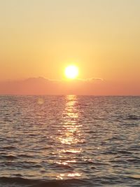 Scenic view of sea against orange sky