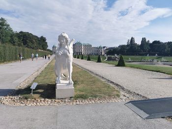 Statue in park against sky