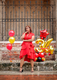 Portrait of a smiling girl holding balloons