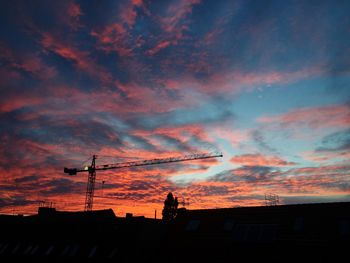 Low angle view of silhouette buildings against sky during sunset