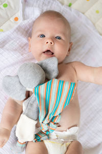 High angle view of cute baby girl sleeping on bed at home