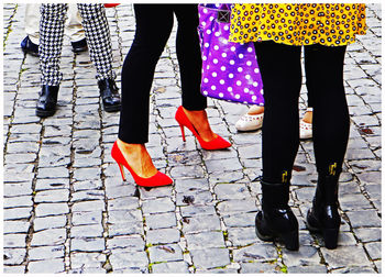 Low section of women standing on footpath