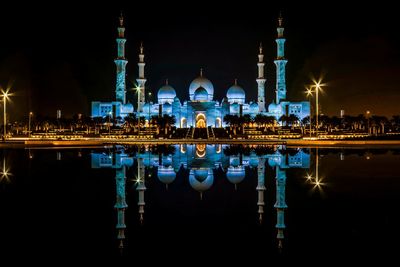Reflection of illuminated buildings in water at night