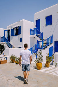 Rear view of man standing against building