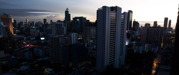 Aerial view of illuminated buildings in city against sky