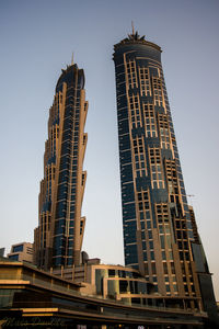 Low angle view of skyscrapers against clear sky