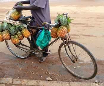 Low section of woman standing on bicycle