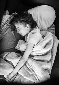 High angle view of woman lying on bed at home