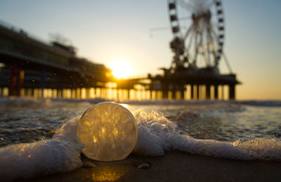 Close-up of water at beach during sunset