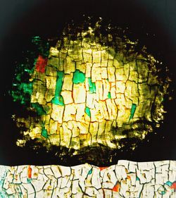 Full frame shot of illuminated lighting equipment against black background