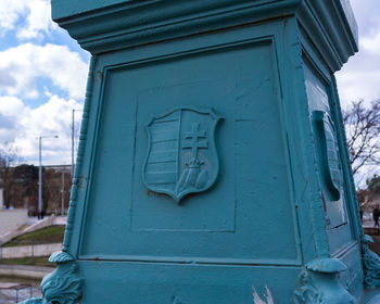 Text on door of building against sky