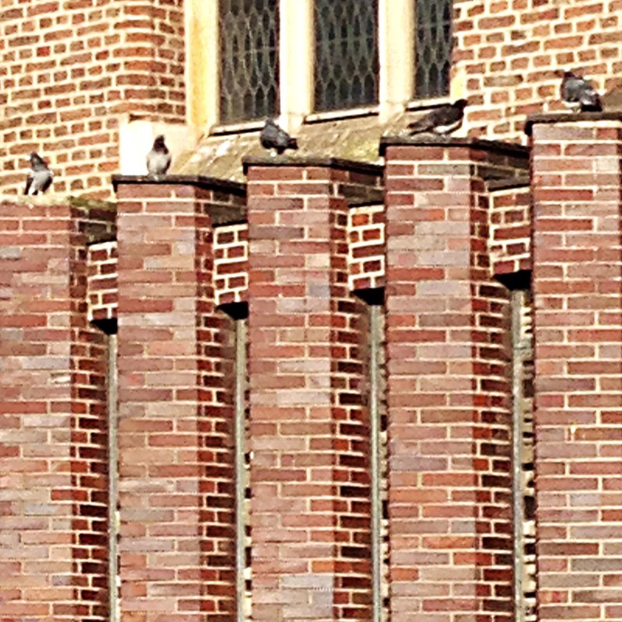 architecture, building exterior, built structure, brick wall, full frame, backgrounds, window, wall - building feature, old, building, brick, repetition, outdoors, metal, day, pattern, no people, in a row, weathered, low angle view