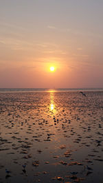 Scenic view of sea against sky at sunset