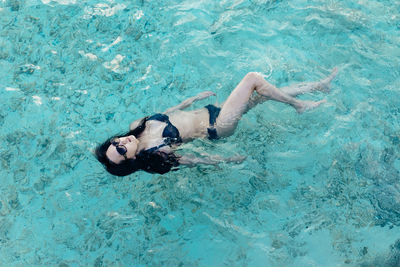 Woman swimming in a crystal clear ocean