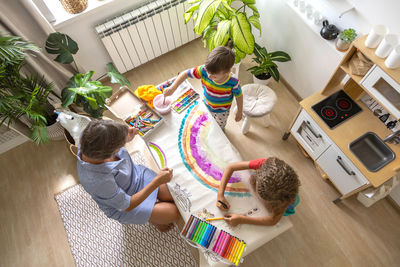 High angle view of boy playing with christmas tree