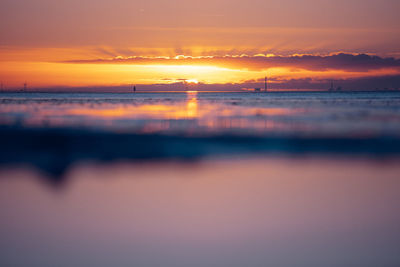 Scenic view of sea against romantic sky at sunset